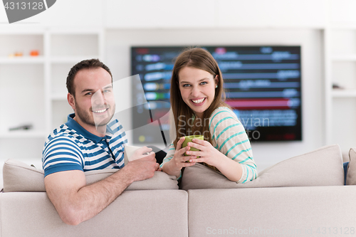 Image of young handsome couple enjoying morning coffee