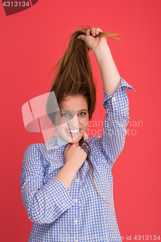 Image of woman playing with her long silky hair