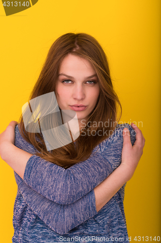 Image of pretty woman playing with her long silky hair