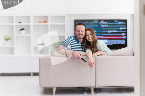 Image of Young couple on the sofa watching television