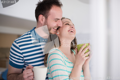 Image of young handsome couple enjoying morning coffee