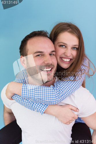 Image of young man piggybacking his girlfriend