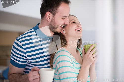 Image of young handsome couple enjoying morning coffee