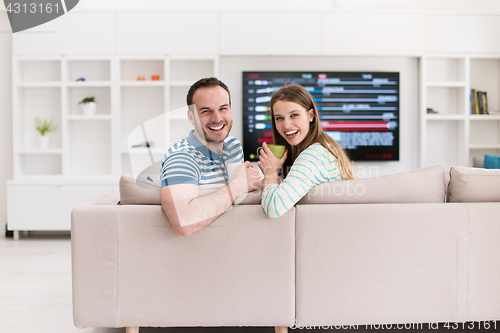 Image of young handsome couple enjoying morning coffee