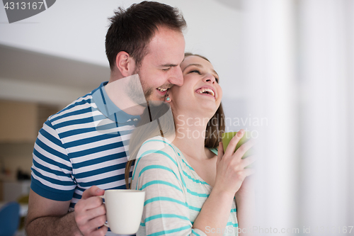 Image of young handsome couple enjoying morning coffee