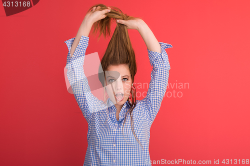 Image of woman playing with her long silky hair