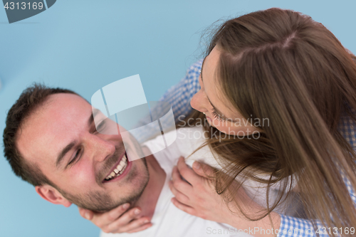 Image of young man piggybacking his girlfriend