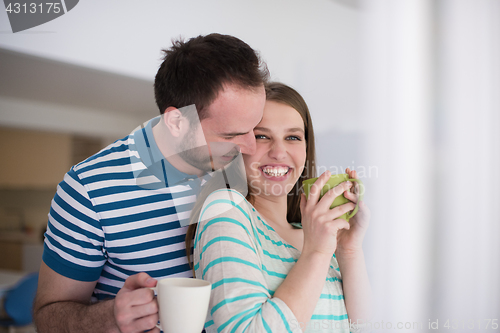 Image of young handsome couple enjoying morning coffee