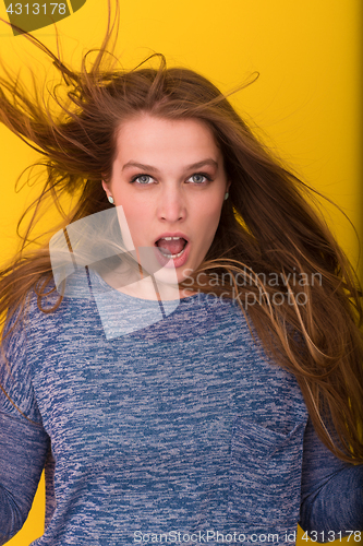 Image of pretty woman playing with her long silky hair