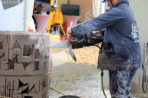 Image of Man Saws Concrete with ICS Chain Saw