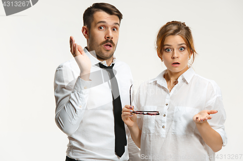 Image of The business man and woman communicating on a gray background