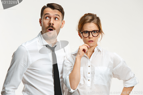 Image of The business man and woman communicating on a gray background