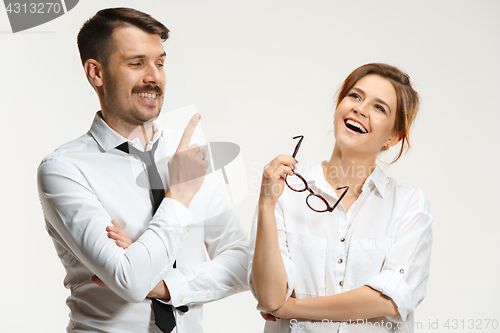 Image of The business man and woman communicating on a gray background