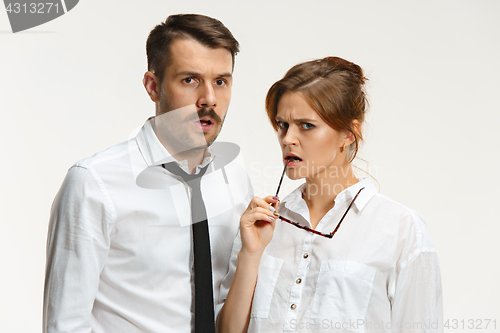 Image of The business man and woman communicating on a gray background