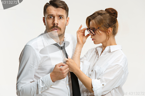 Image of The business man and woman communicating on a gray background