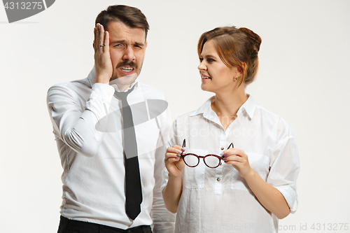 Image of The business man and woman communicating on a gray background