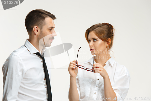 Image of The business man and woman communicating on a gray background