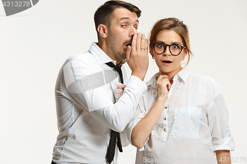 Image of The business man and woman communicating on a gray background