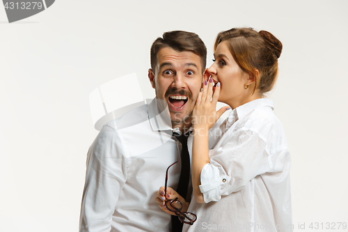 Image of The business man and woman communicating on a gray background
