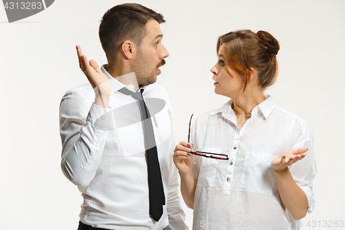 Image of The business man and woman communicating on a gray background