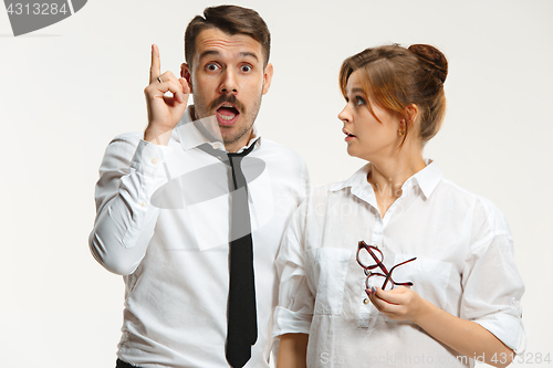 Image of The business man and woman communicating on a gray background