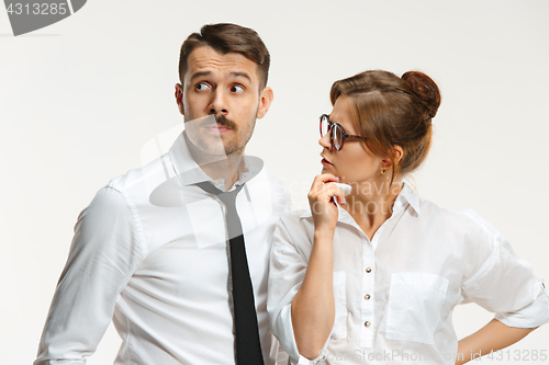 Image of The business man and woman communicating on a gray background