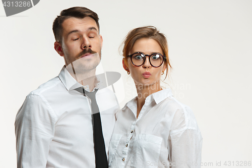 Image of The business man and woman communicating on a gray background