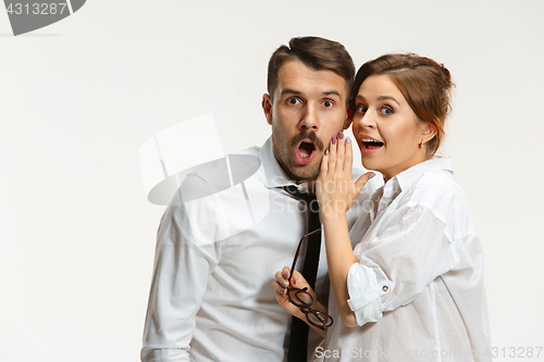 Image of The business man and woman communicating on a gray background