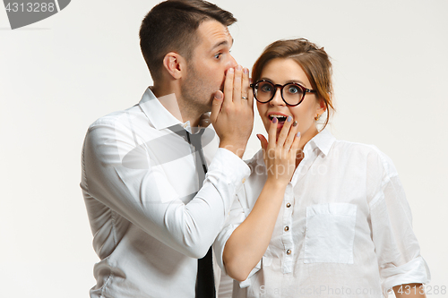 Image of The business man and woman communicating on a gray background