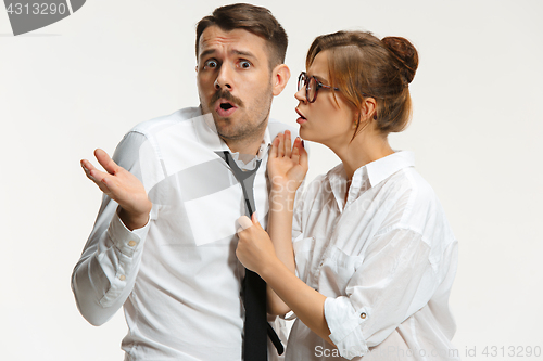 Image of The business man and woman communicating on a gray background