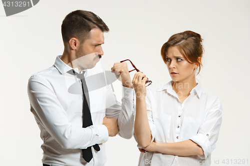 Image of The business man and woman communicating on a gray background