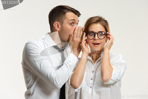 Image of The business man and woman communicating on a gray background