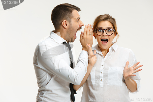 Image of The business man and woman communicating on a gray background