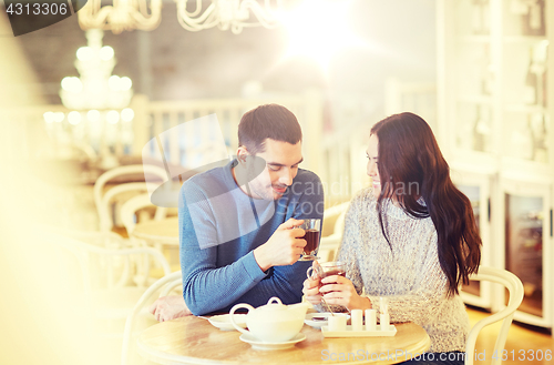 Image of happy couple drinking tea at cafe