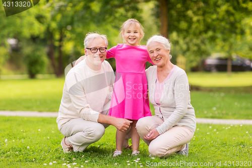 Image of senior grandparents and granddaughter at park