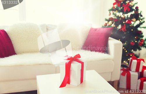 Image of close up of christmas gift box on table at home