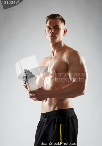 Image of young man or bodybuilder with protein shake bottle