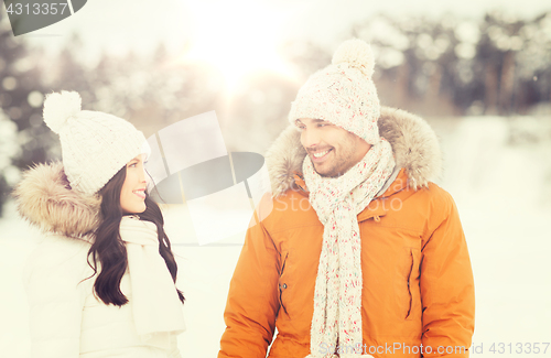 Image of happy couple walking over winter background