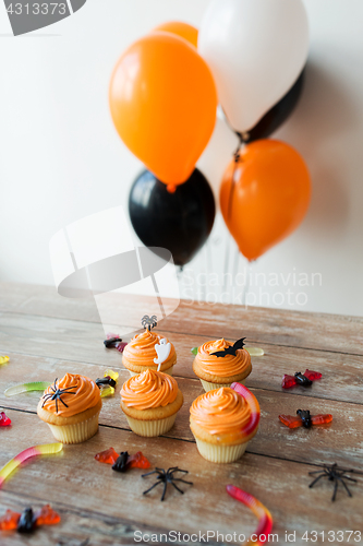 Image of halloween party cupcakes and candies on table