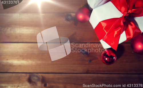 Image of close up of gift boxes and red christmas balls