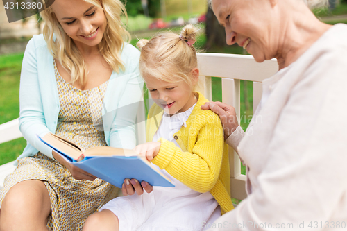 Image of woman with daughter and senior mother at park