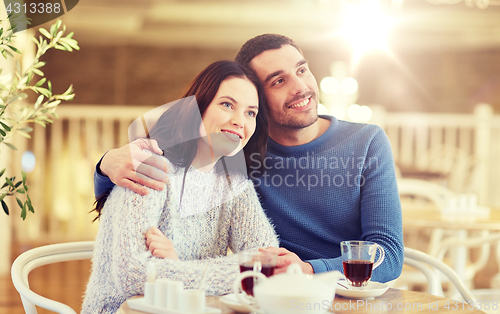 Image of happy couple drinking tea at restaurant