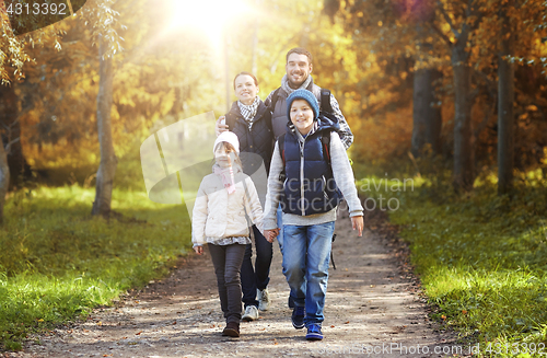 Image of happy family with backpacks hiking