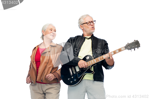 Image of happy senior couple with electric guitar