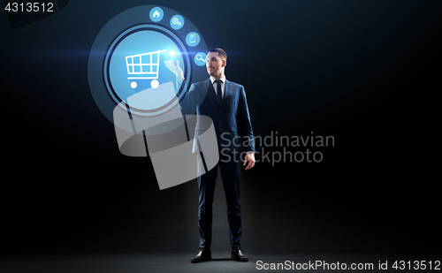 Image of businessman with shopping cart on virtual screen