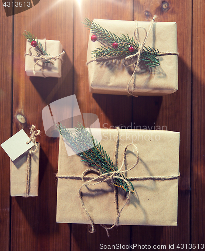 Image of close up of christmas gifts with fir brunch