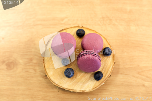 Image of blueberry macarons on wooden stand