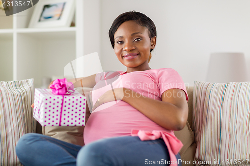 Image of happy african american pregnant woman with gift