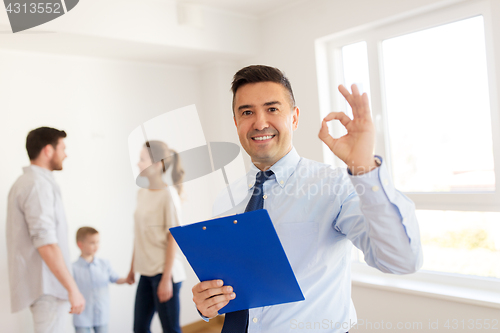 Image of realtor with clipboard and family at new home