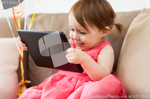 Image of baby girl with tablet pc at home